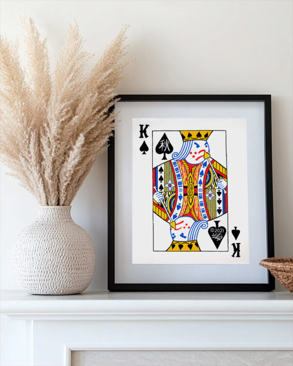 8x10 inch King of Spades in a frame sitting on a mantel.